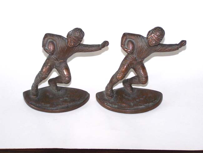 A pair of Antique Cast Iron Bookends depicting a Football Player from the 1920's.